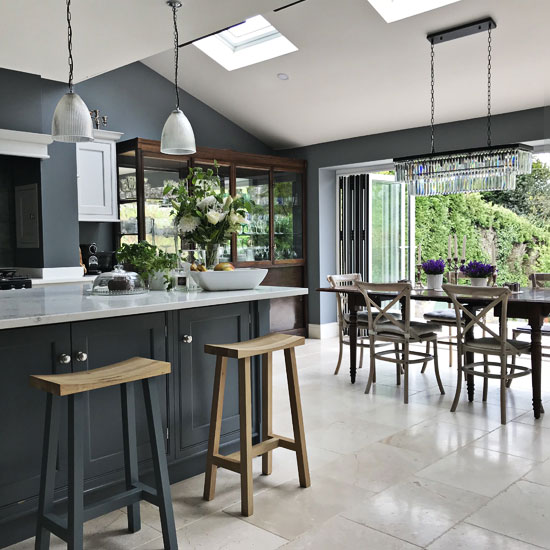Photo of open plan kitchen dining space with view to garden as part of interior design Devon project.
